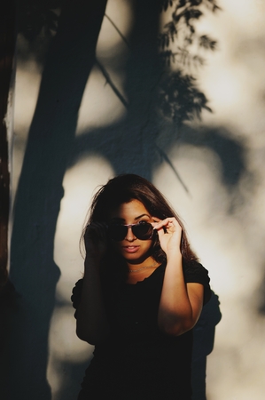 Sexy brunette in sunglasses outside posing. Portrait of a young woman.の写真素材