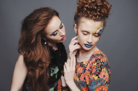 Glamorous ladies. Sensual young women with artistic make-up.の写真素材