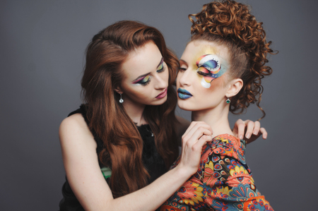 Glamorous ladies. Sensual young women with artistic make-up.の写真素材