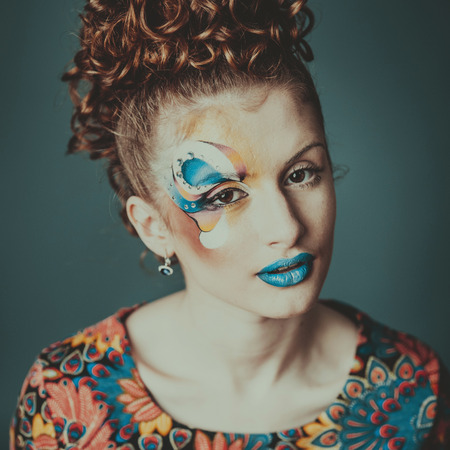 Visage contest. Sensual young woman with artistic make-up. Glamourous lady.の写真素材
