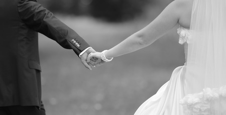 Hands of wedding couple. Picture in black and white. Togetherness.の写真素材