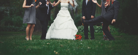 Happy bridal couple with guests  in garden. Summer wedding picture.の写真素材