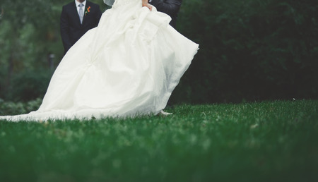 Summer picture of happy wedding couple outside.の写真素材