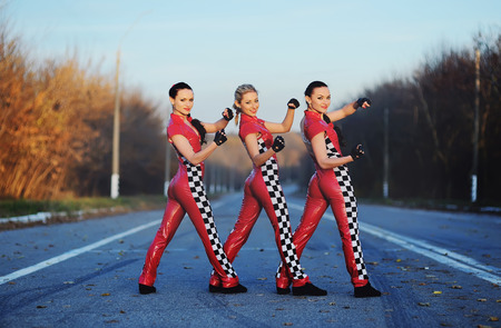 thre girls mechanics on a roadの写真素材