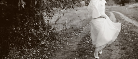 Portrait of beautiful bride wearing wedding dress in countryside.の写真素材