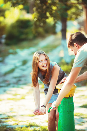 Teenage girl having fun outside. Young couple together.の写真素材