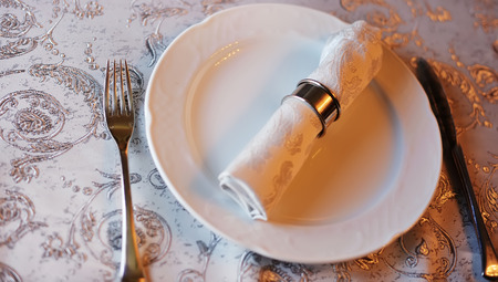 empty plate on served table in restaurantの写真素材