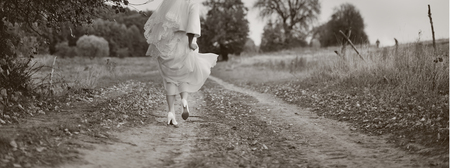 Portrait of beautiful bride wearing wedding dress in countryside.