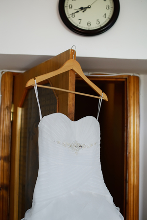 Wedding dress hanging on the doorの写真素材