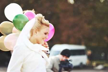 Gorgeous caucasian bride in beautiful dress with balloons.の写真素材