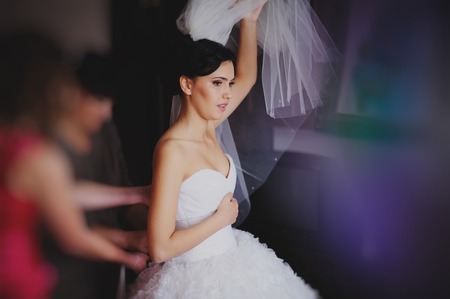 Beautiful bride in wedding dress getting ready for weddingの写真素材