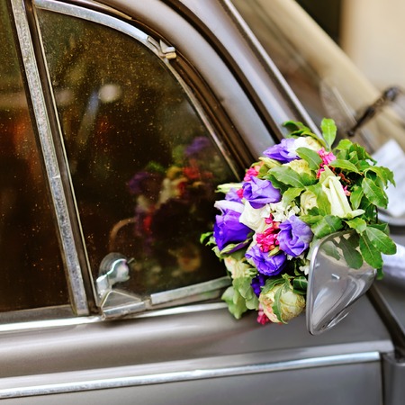 Wedding bouquet of various flowers on vintage silver carの写真素材