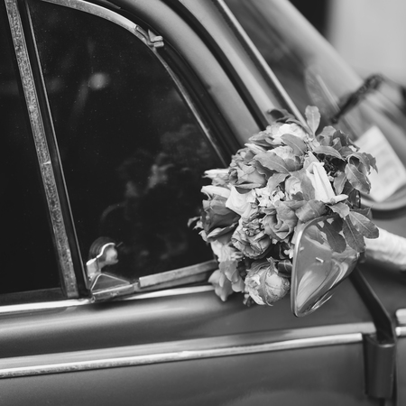 Bridal bouquet of various flowers on vintage silver car, picturの写真素材