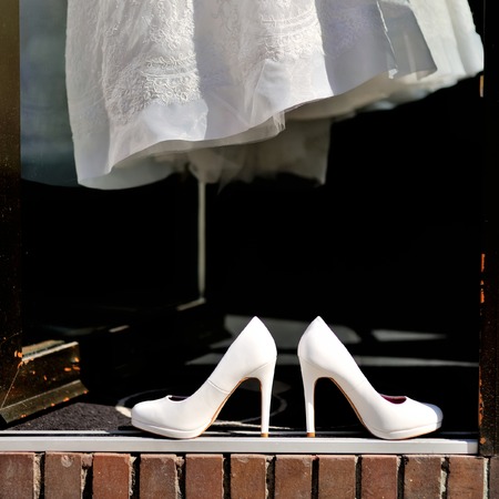 Bridal shoes and wedding dress on entranceの写真素材