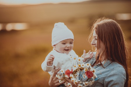 Happy young mom with lovely daughter at countryside.の写真素材
