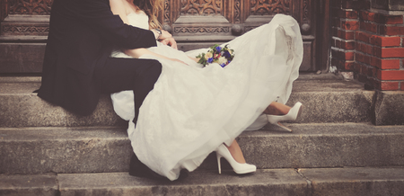 Happy bride and groom on steps of church in Copenhagen. Wedding couple together.の写真素材