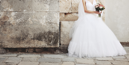 bride posing with bouquet outside, wedding photoの写真素材