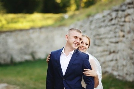 Wedding Couple next to old castle, newlyweds in love togetherの写真素材