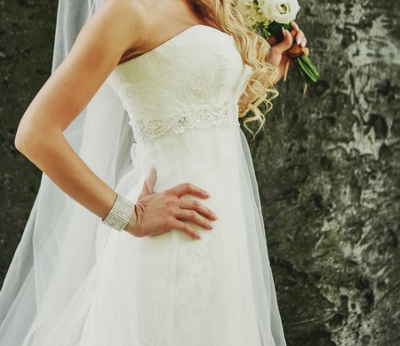 Beautiful young bride with bouquet on wedding day.の写真素材