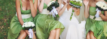 bride with bridesmaids and bouquet of white flowersの写真素材
