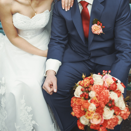 wedding couple sitting on a benchの写真素材