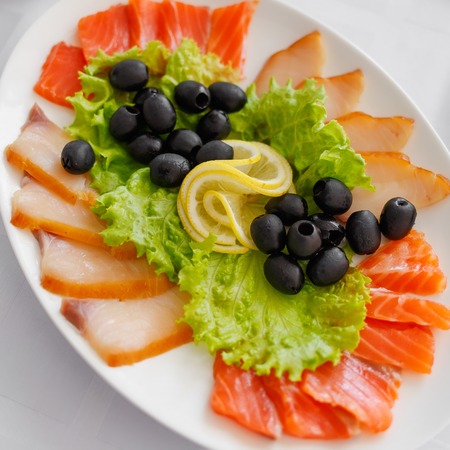 Salmon olives and lemon on plate. Banquet Table in restaurant served with different meals. Ready for wedding reception.の写真素材