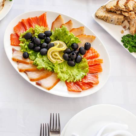 Salmon olives and lemon on plate. Banquet Table in restaurant served with different meals. Ready for wedding reception.の写真素材