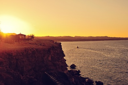 Sunset over sea, golden sky horizon