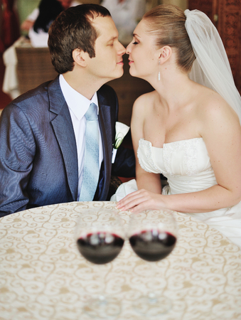 Newlyweds in restaurant spending happy wedding day together.の写真素材