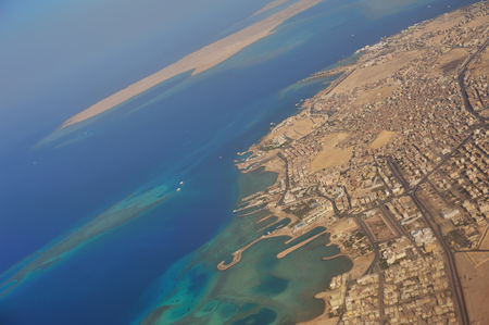 Looking through window aircraft during flight, flying over Egyptの写真素材
