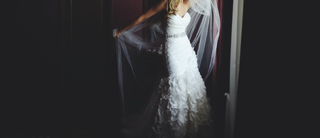 young bride getting ready in hotel room, wedding photography