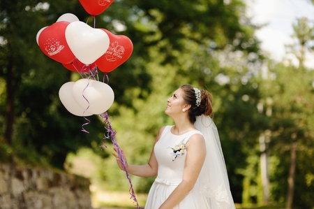 young bride with balloons at street, wedding photographyの写真素材
