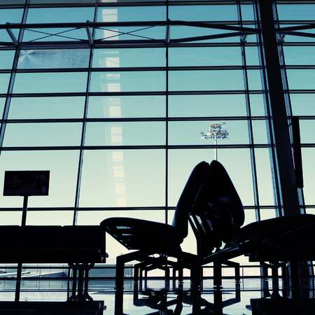 Waiting room with lot of seats, departure terminal in airport, blue toneの写真素材