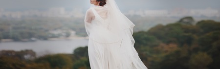 young bride in white dress on cityscape backgroundの写真素材
