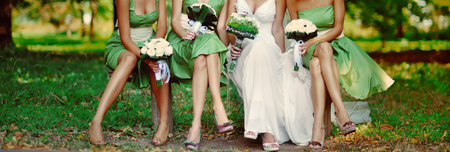bride with bridesmaids and bouquet of white flowersの写真素材