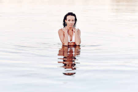 sexy fitness girl posing in by a seaの写真素材