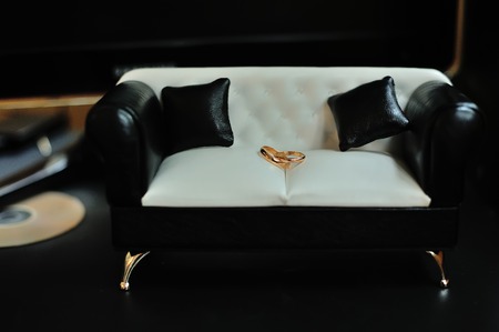 wedding golden rings on mini sofaの写真素材