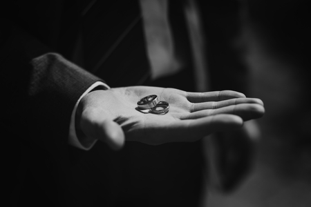 Groom holding wedding rings, waits for his brideの写真素材