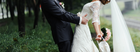 Happy young newlywed couple out in the nature. The wedding dayの写真素材