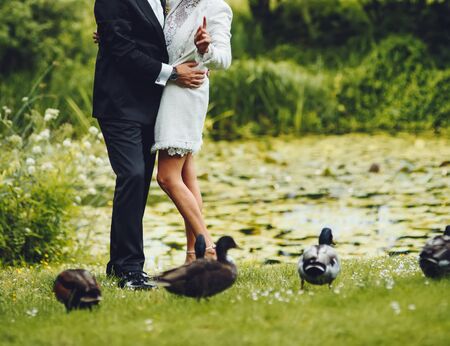 Bridal couple having their marriage ceremony in the botanical garden.の写真素材