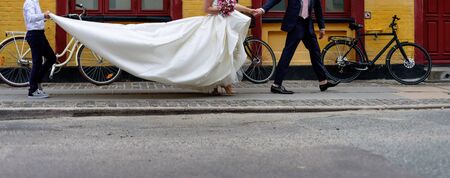 Bride walking a street wearing long classic wedding dress.の写真素材