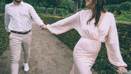 Follow the beautiful bride. Wedding couple walking together.の写真素材