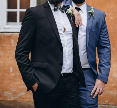 Newlywed stylish gay couple on their happy wedding day. Equality concept.