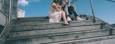 Young bridal couple kissing on wooden stairs.の写真素材