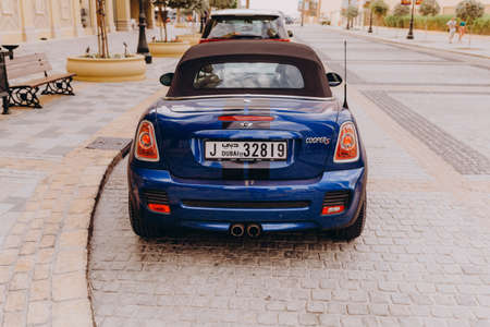 Dubai, UAE - November 20, 2013. Blue Mini Cooper S car parked in Dubai Marina disctrict.