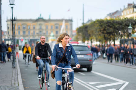 Copenhagen, Denmark 10 May 2018. Man and woman in jeans ride bicycles in Copenhagen, lifestyle of Denmark.のeditorial素材