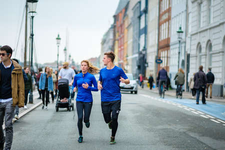 Copenhagen, Denmark 10 May 2018. A couple jogging in the Nyhavn area, healthy lifestyle of Denmark.のeditorial素材