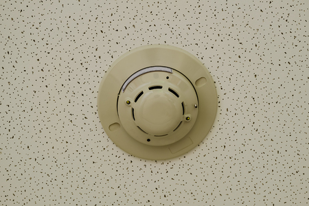 Smoke detector on ceiling in safety zone room.の写真素材