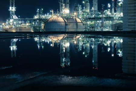 Glowing lights of petrochemical plant and water reflection at nighttime, Factory with night, Oil and gas refinery industrialの写真素材