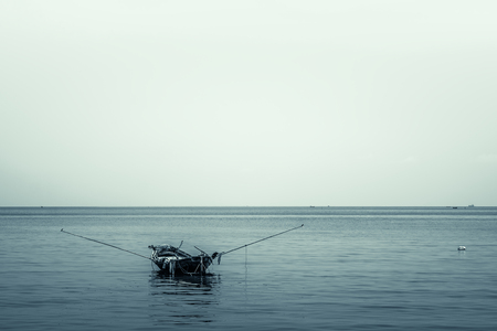 Fishing boat anchored on sea with copy space, Vintage background, Monotone colorの写真素材